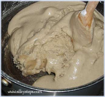 Stir the sand mixture as it begins to form a dough