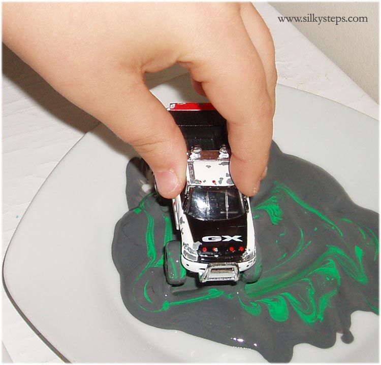 Dip car wheels into paint to mark make on roads